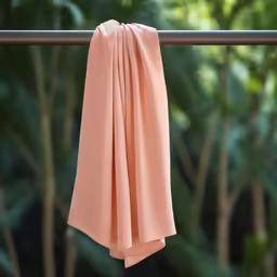 a pink napkin hanging off the side of a balcony