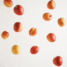 a group of apricots fall into the air