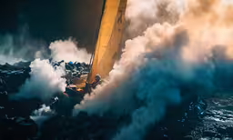 an aerial view of a smoke plume in the ocean