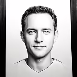 a black and white photo of a man in front of a wall