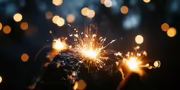 a close up shot of a sparkler on top of a snow covered rock