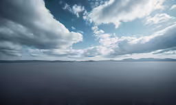 a large expanse of sand under a cloudy sky