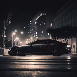 a black sports car parked on the road at night