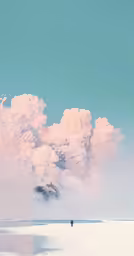 two people stand on a beach under a cloudy sky
