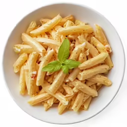 pasta in white sauce and topped with basil