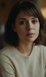 a woman sitting at the table looking off to the right