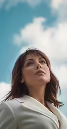 woman with her head above the clouds and looking off to the side