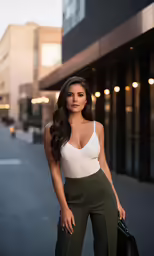 a woman with long hair wearing a tan and green crop top