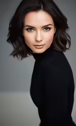 a beautiful young woman with brown hair posing for a studio photo