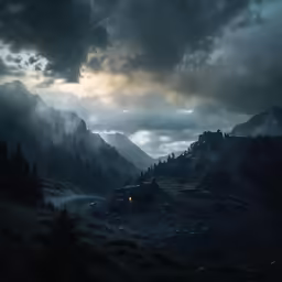 a forest is silhouetted against a dark sky with clouds