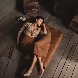 a beautiful woman laying on top of a couch