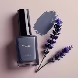 a nail polish bottle next to lavenders and a mirror