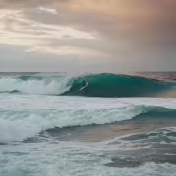 a surfer is riding the very strong waves