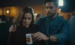 a couple looking at something in their hands