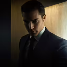 a man in a suit and tie looking away
