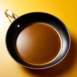 a pan that is sitting on a yellow surface