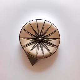 a clock is sitting on a table with a white background