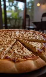 a pizza cut into four slices sitting on a table