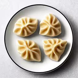 dumplings sitting on a plate with black trim