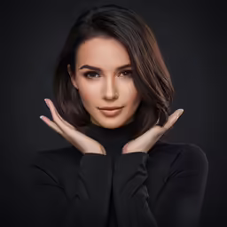a woman with her arms crossed looking into the camera