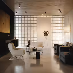 a living room filled with furniture and wall hangings