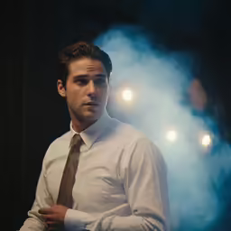 there is a man standing alone with smoke behind him