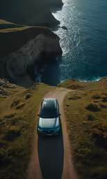 there is a car that is sitting on the road by the water