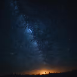 there are stars and the sky with trees in it