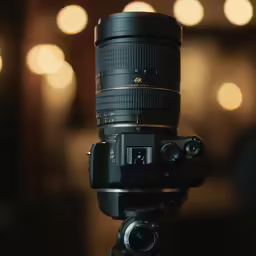 a camera lens on top of a tripod with focus on the lens