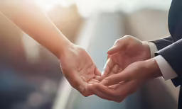 two people hold their hands together and give each other a hand shake