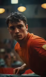 a boy with a shirt on and a tennis racket in front of him