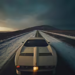 a car driving down the road on a snowy day