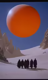 the group of people are all walking near one another