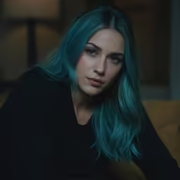 a woman with blue hair posing for a picture