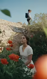 two people standing on top of a rocky hillside