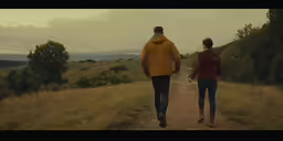 two people walking down the road holding hands