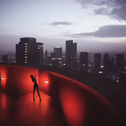 woman standing on top of a building in the city