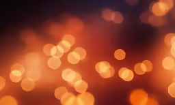 an orange background with blurry circles of light