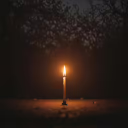 a candle with one light lit up in the middle