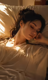 a woman is sleeping in bed with her eyes closed