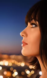 the woman is staring over the city lights at night