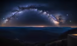 the milky is visible over the mountains in the distance