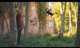 a man that is standing next to some trees