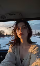woman in car looking out the window at the winter scene