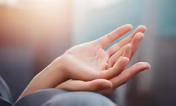 a person holds their hand out for someone to touch it