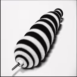 a black and white stripped umbrella laying flat on a table