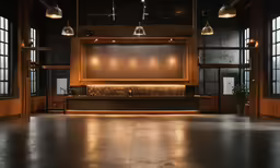 an empty room with some lights hanging from the ceiling