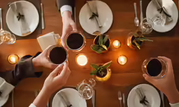 several people are raising their glasses to toast at the table