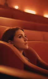 the actress is in an empty theater looking out over her shoulder