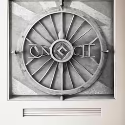 the emblem is on a wall above a window